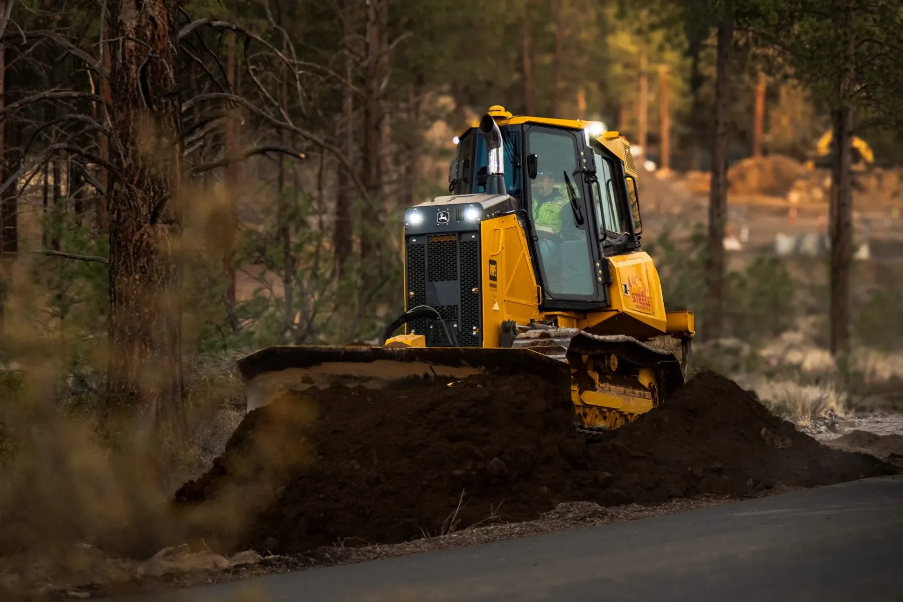 A Steele Earthworks operator running a dozer at golden hour