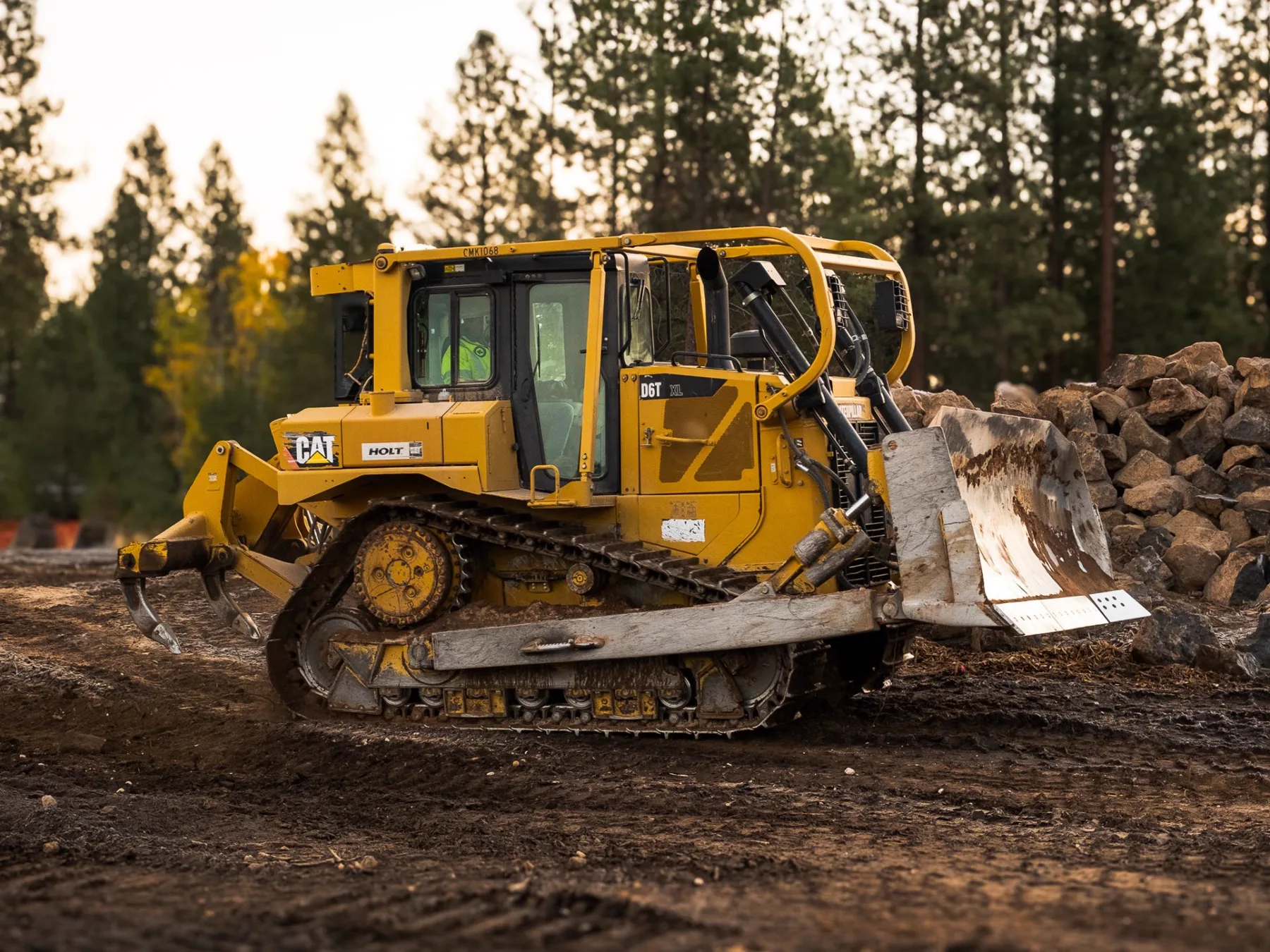 A Steele Earthworks operator running a dozer at golden hour in Central Oregon